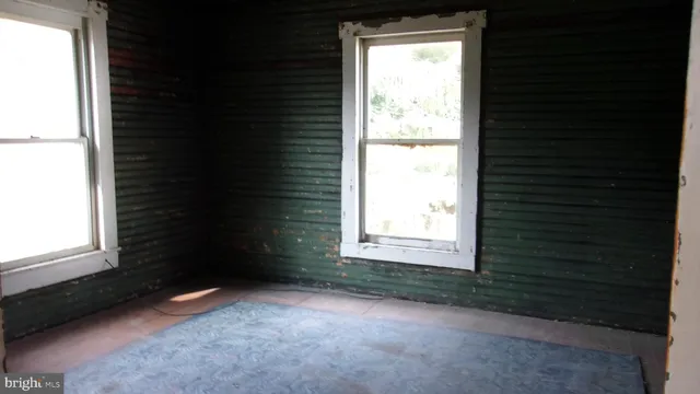 a view of an empty room and a window