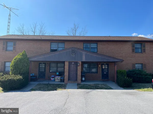 a view of a house with a patio and a yard