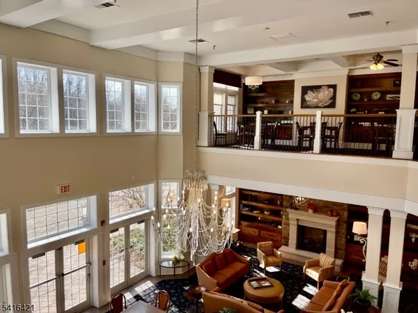 a room with pool table and windows