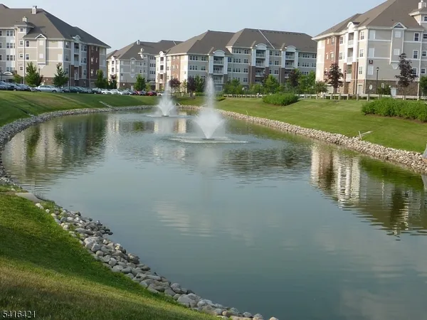 a view of a patio with a dining table and chairs under an umbrella