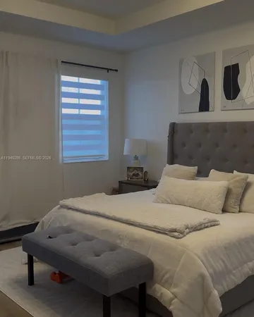 a bedroom with a bed and cabinets