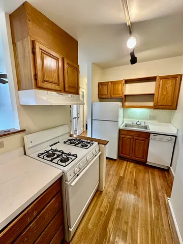 a kitchen with a stove a sink and a microwave