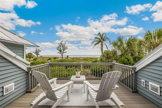 a view of a chair and tables on the balcony