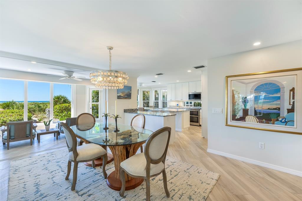 22 Seawatch Drive Boca Grande, FL 33921 - Photo 11 of 72 a dining room with furniture a chandelier and wooden floor