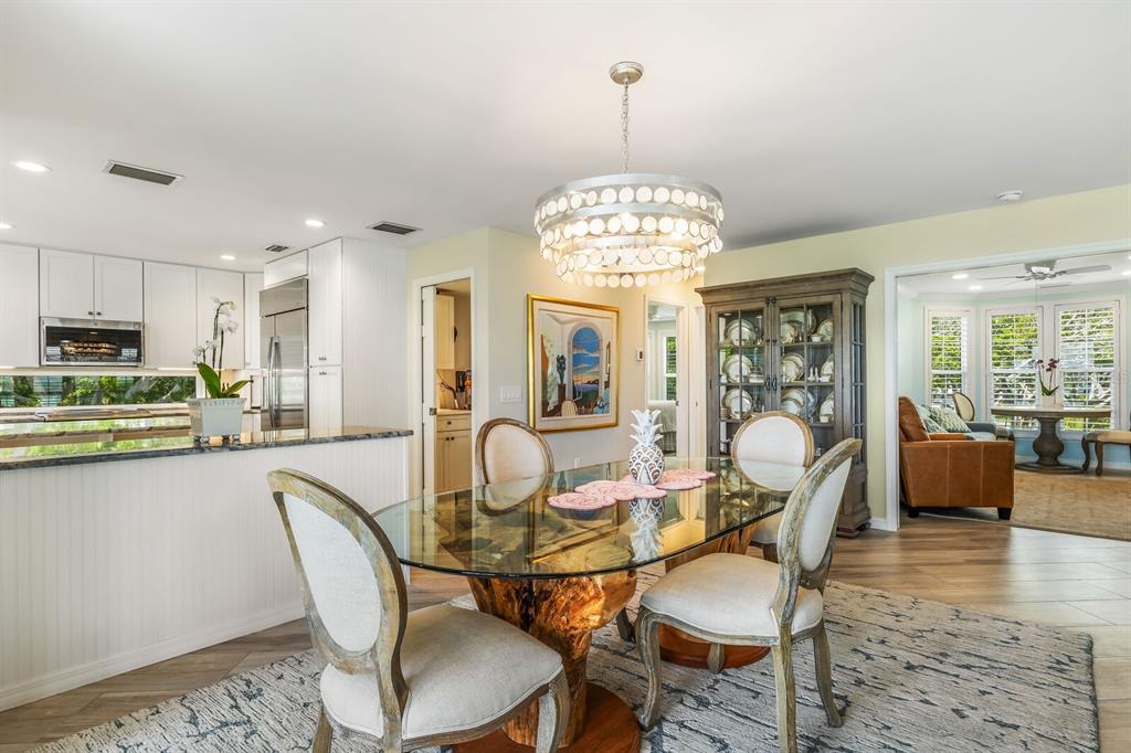 22 Seawatch Drive Boca Grande, FL 33921 - Photo 12 of 72 a view of a dining room with furniture a chandelier and wooden floor