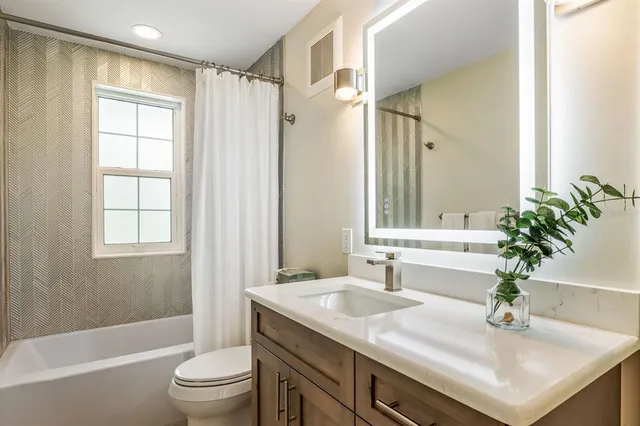 a living room with furniture and large windows