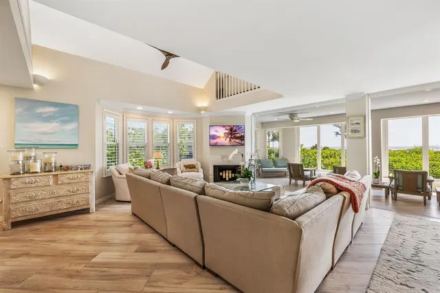 a living room with furniture potted plant and a chandelier