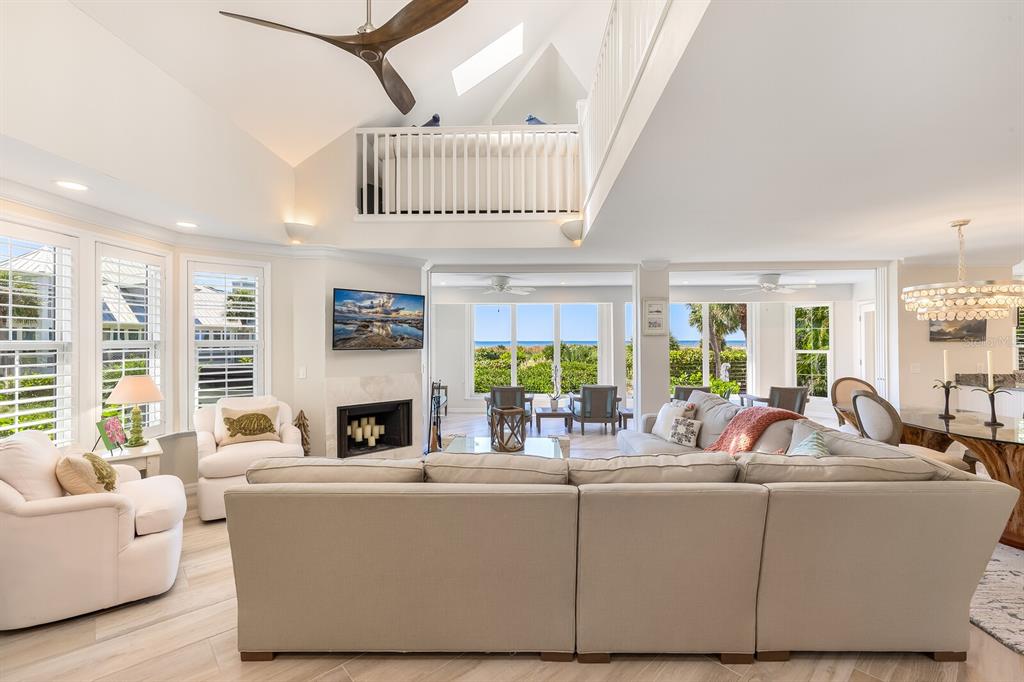 22 Seawatch Drive Boca Grande, FL 33921 - Photo 7 of 72 a living room with furniture a fireplace and a floor to ceiling window