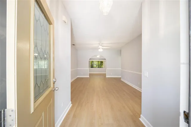 a view of a hallway with wooden floor and staircase