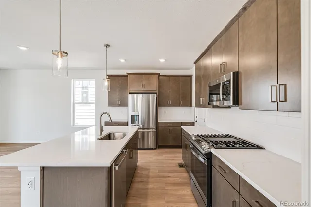 a kitchen with a white cabinets and stainless steel appliances