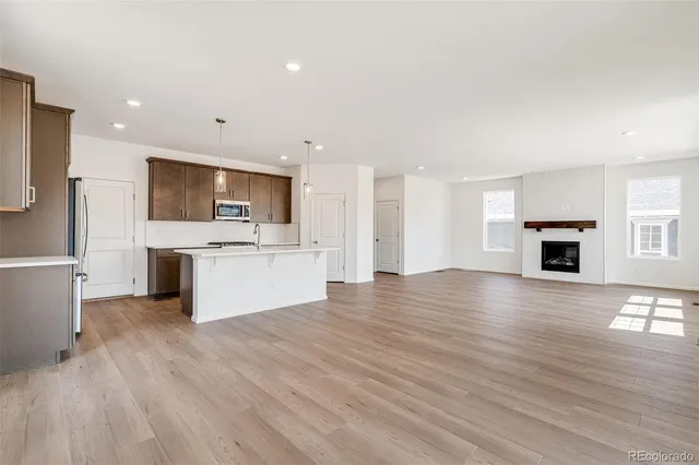 a view of kitchen with refrigerator stove microwave and cabinets