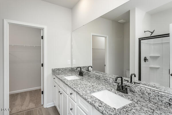 64 Foxton Place Angier, NC 27501 - Photo 19 of 26 a bathroom with a granite countertop sink and a mirror