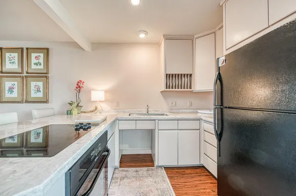 a kitchen with a sink stove and refrigerator