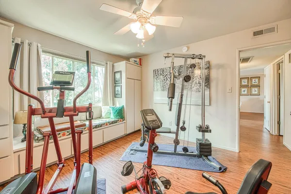 a view of a livingroom with furniture wooden floor and windows