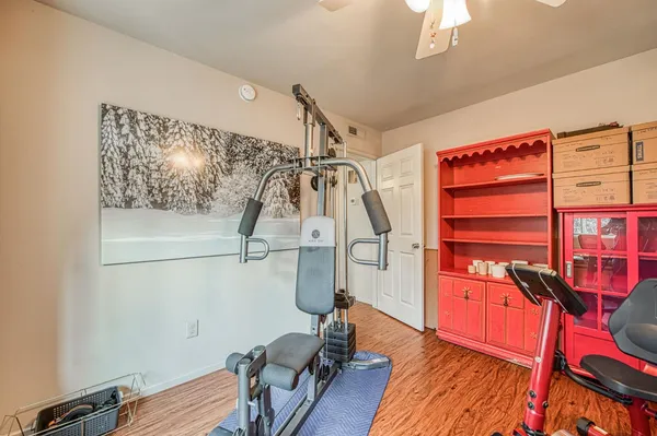 a view of a room with wooden floor and windows