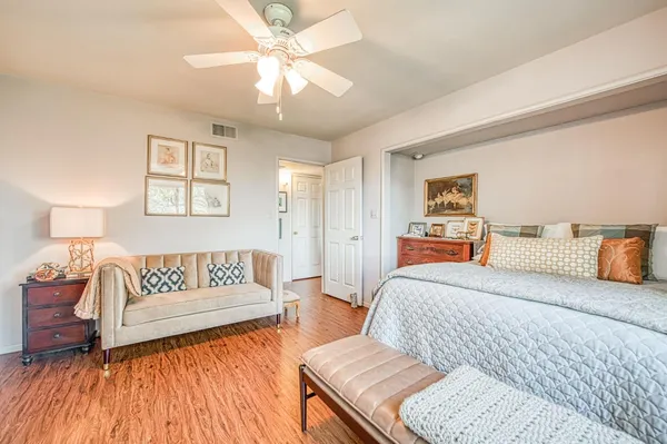 a spacious bedroom with a bed and a couch