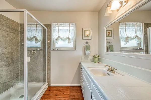 a bathroom with a bathtub a sink and a window