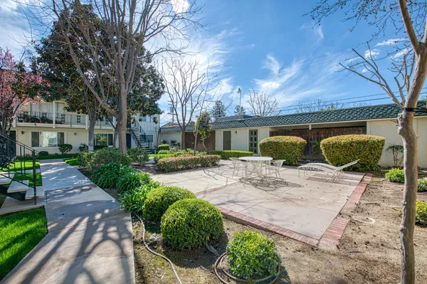 a view of a backyard with patio area
