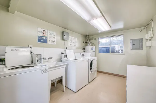 a utility room with cabinets washer and dryer