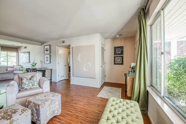 a bedroom with furniture and wooden floor