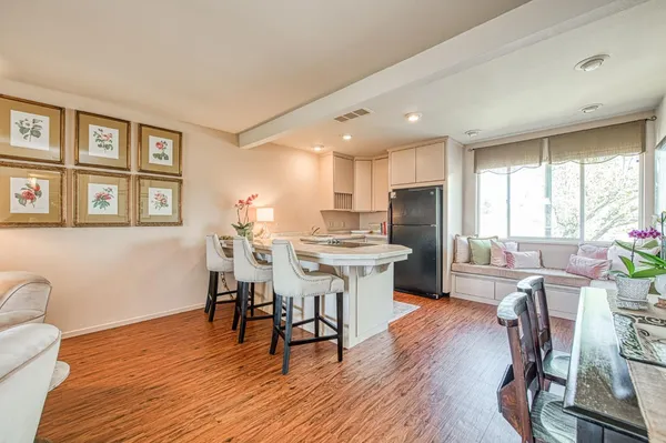 a view of a dining room with furniture window and wooden floor