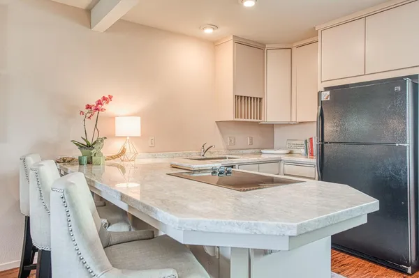 a kitchen with kitchen island a sink stove and refrigerator