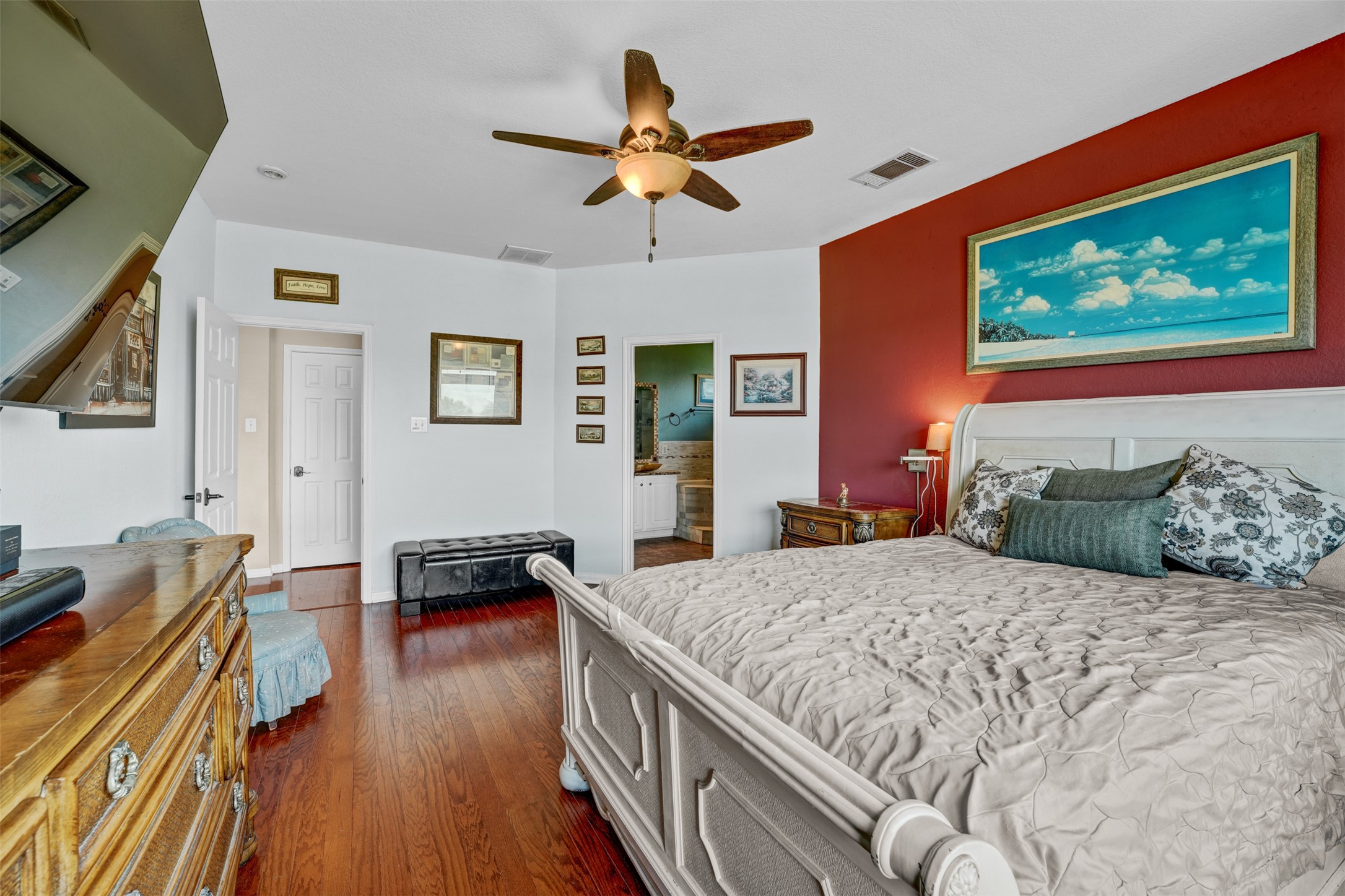 2521 Amen Corner Road Pflugerville, TX 78660 - Photo 18 of 40 Spacious room featuring wood-finish flooring, a ceiling fan, and a vibrant accent wall