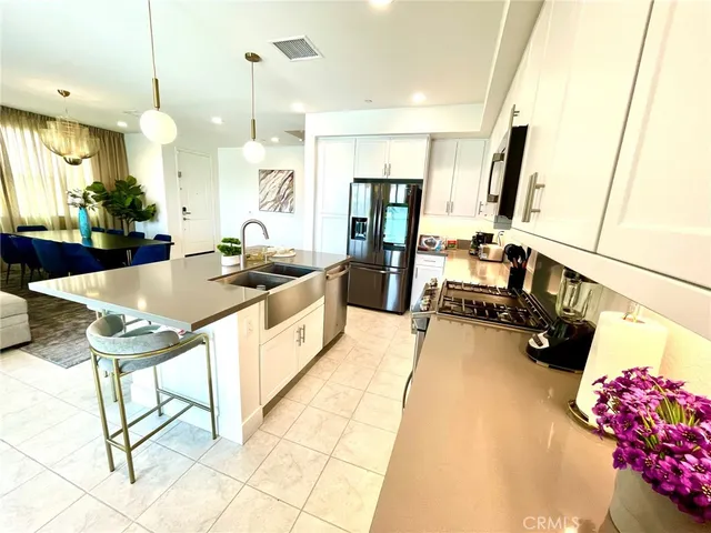 a kitchen with stainless steel appliances kitchen island granite countertop a sink and cabinets