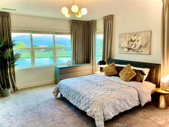 a bedroom with bed and large windows