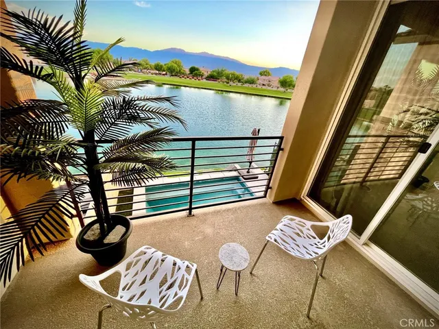 a balcony with table and chairs