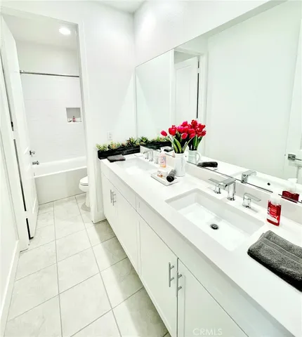 a bedroom with a bed couch and window