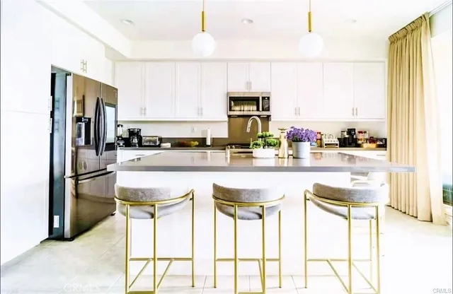 a kitchen with stainless steel appliances a sink and a refrigerator