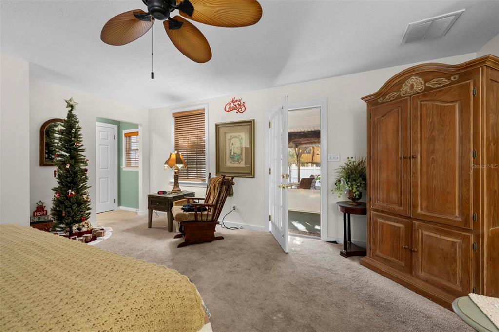16 52nd Street Yankeetown, FL 34498 - Photo 49 of 63 a living room with furniture cabinets and a chandelier