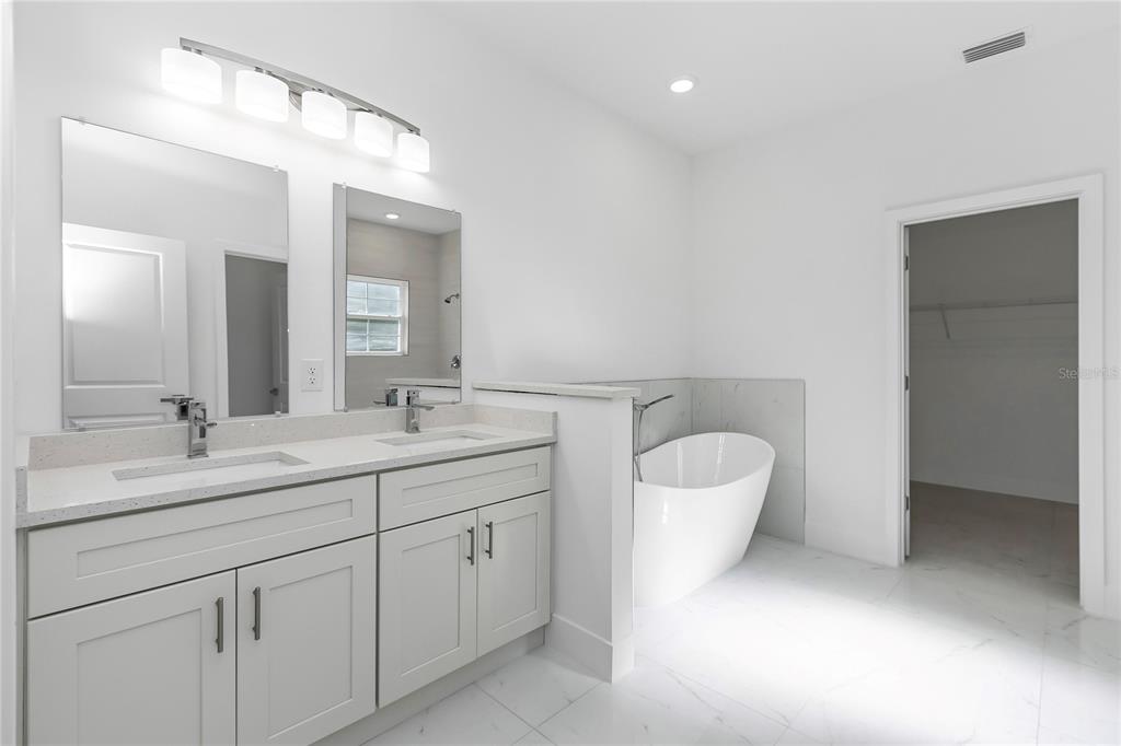 15070 Southwest 21st Ter Road Ocala, FL 34473 - Photo 12 of 47 a bathroom with a toilet a sink and mirror