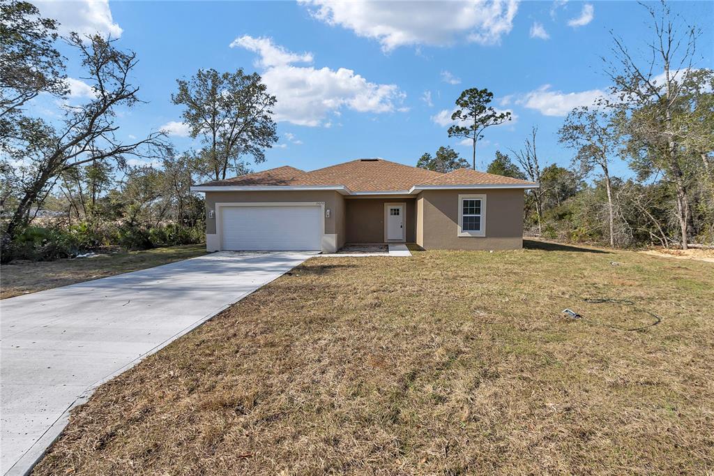 15070 Southwest 21st Ter Road Ocala, FL 34473 - Photo 19 of 47 a front view of a house with a garden