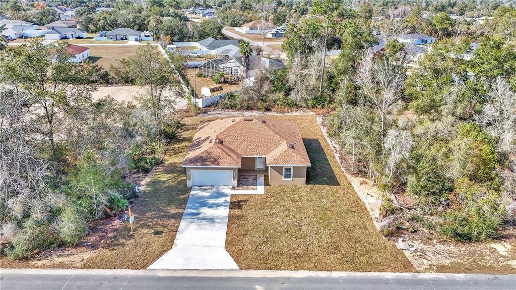 15070 Southwest 21st Ter Road Ocala, FL 34473 - Photo 2 of 47 a view of a large yard with large trees