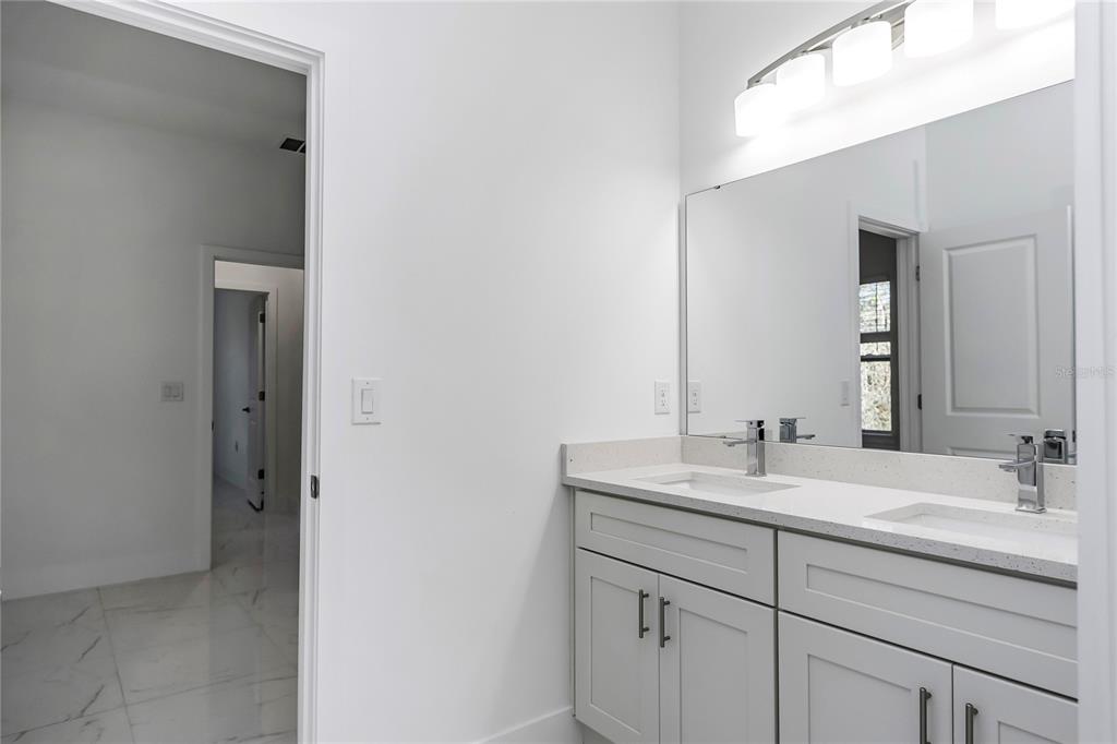 15070 Southwest 21st Ter Road Ocala, FL 34473 - Photo 35 of 47 a bathroom with a sink and a mirror