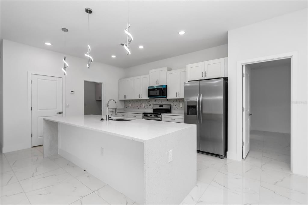 15070 Southwest 21st Ter Road Ocala, FL 34473 - Photo 44 of 47 a kitchen with stainless steel appliances a refrigerator sink and microwave