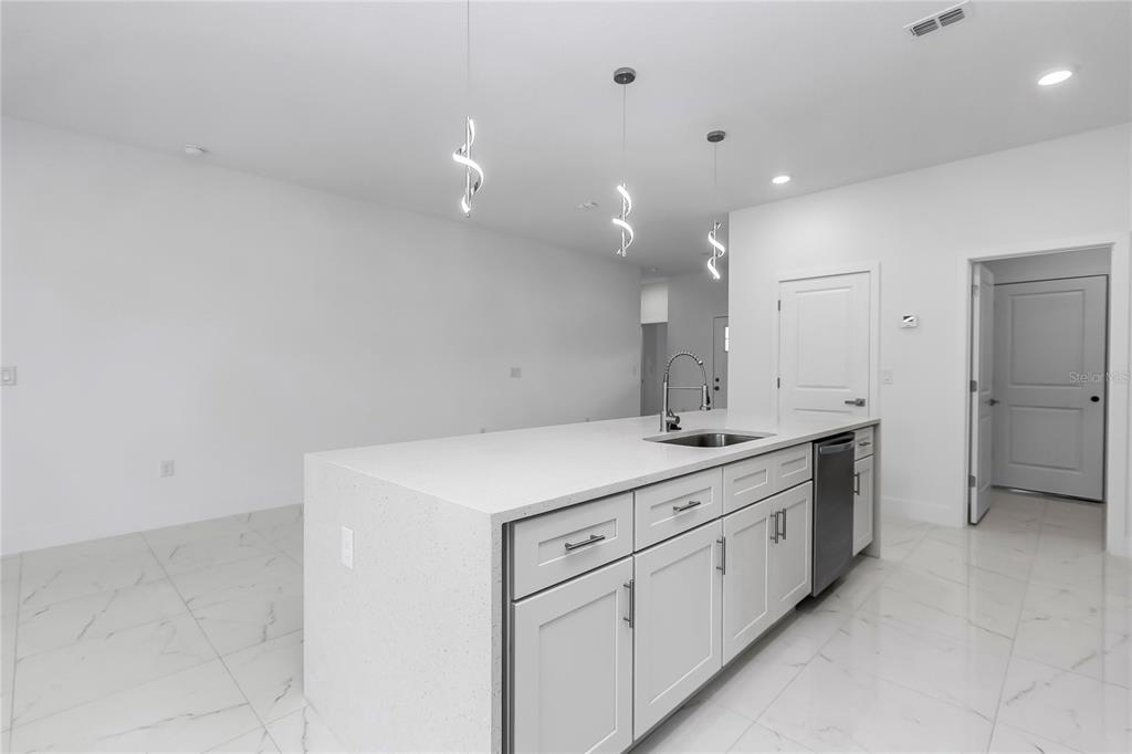 15070 Southwest 21st Ter Road Ocala, FL 34473 - Photo 46 of 47 a kitchen with a sink stove and cabinets