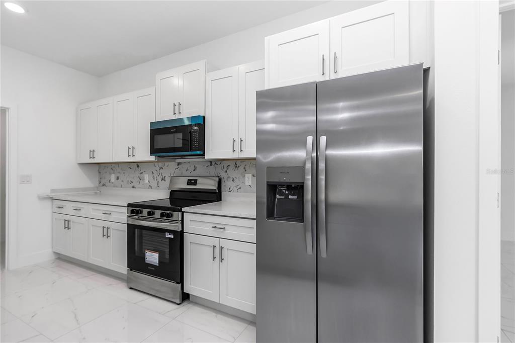 15070 Southwest 21st Ter Road Ocala, FL 34473 - Photo 47 of 47 a kitchen with refrigerator a stove and a sink