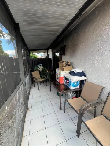 a bedroom with a bed a flat screen tv and dresser