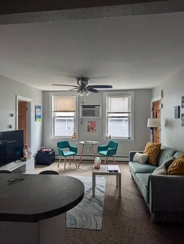 a living room with furniture window and wooden floor