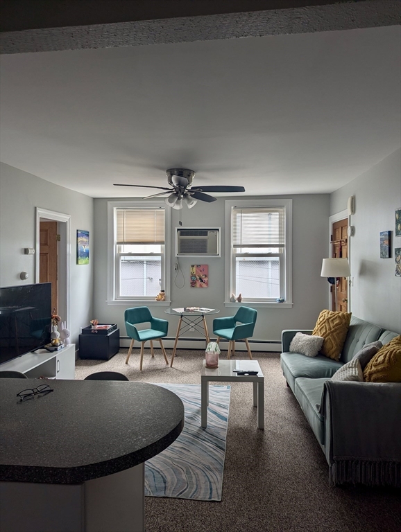 a living room with furniture window and wooden floor