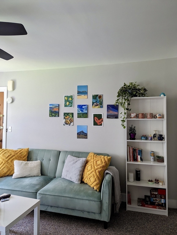 20 Roberts Street, Unit 4 Brookline, MA 02445 - Photo 5 of 8 a living room with furniture and a couch