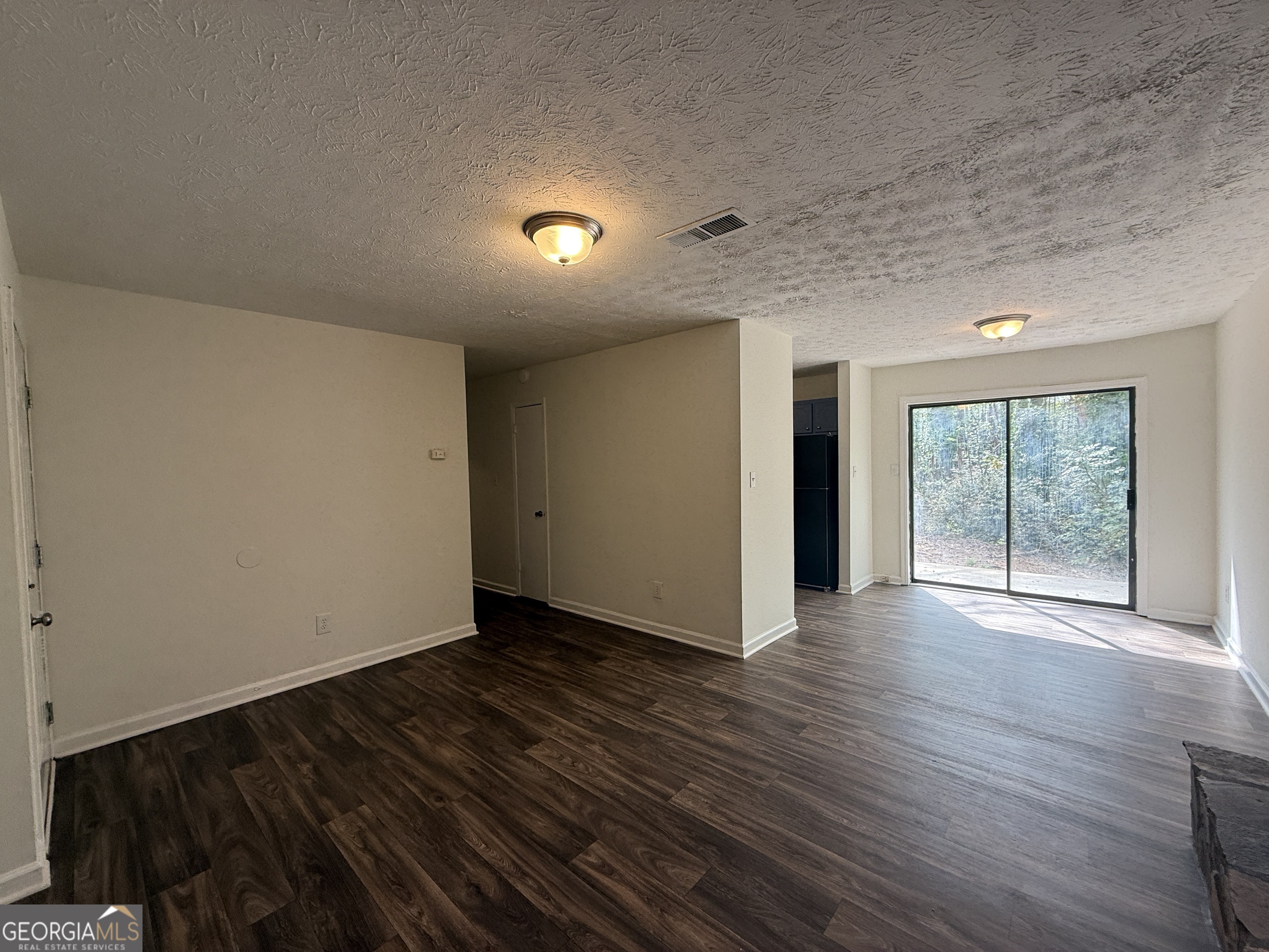 540 Rustwood Drive Athens, GA 30606 - Photo 2 of 6 an empty room with wooden floor and windows