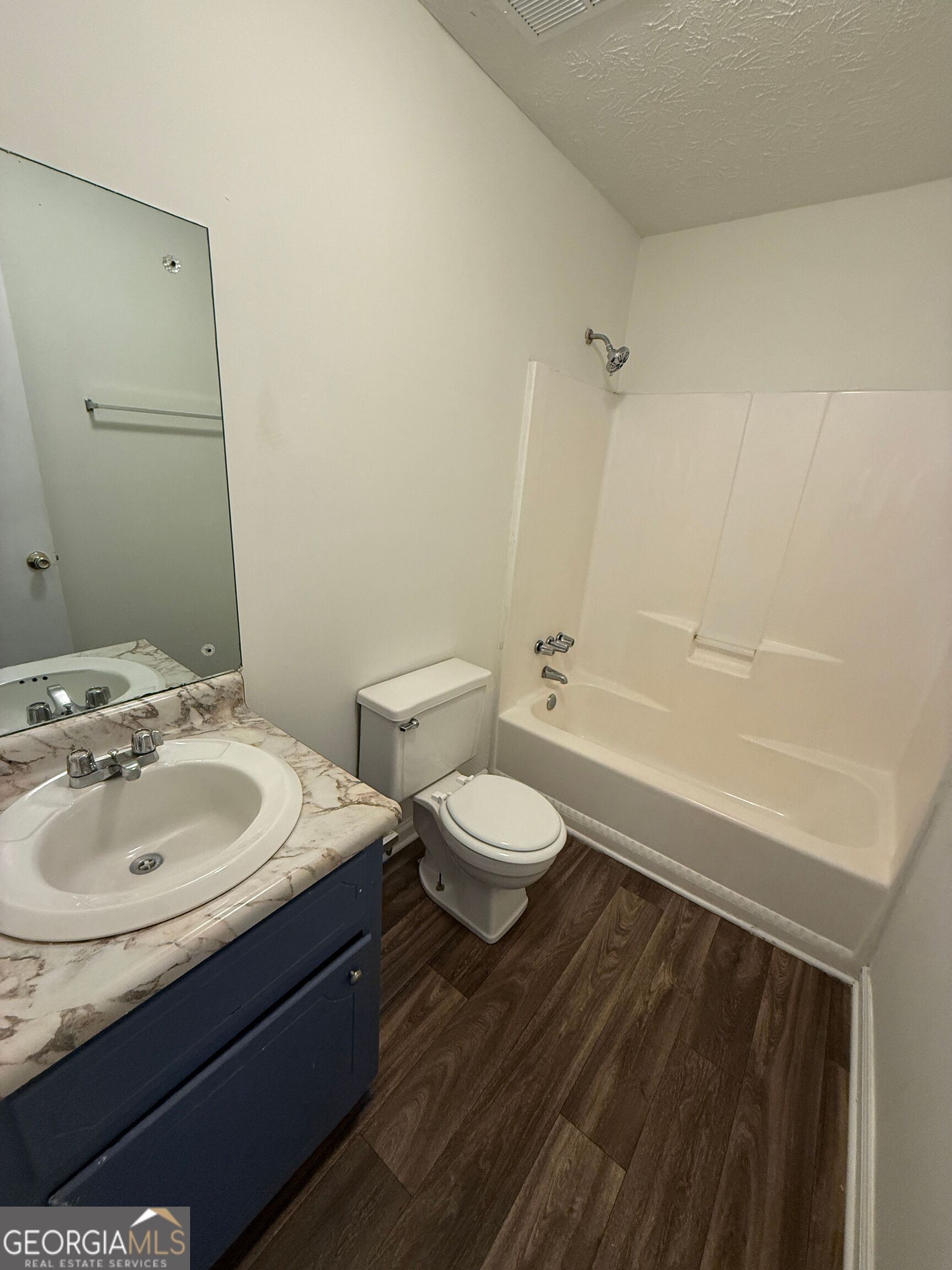 540 Rustwood Drive Athens, GA 30606 - Photo 4 of 6 a bathroom with a granite countertop sink toilet a large mirror and shower