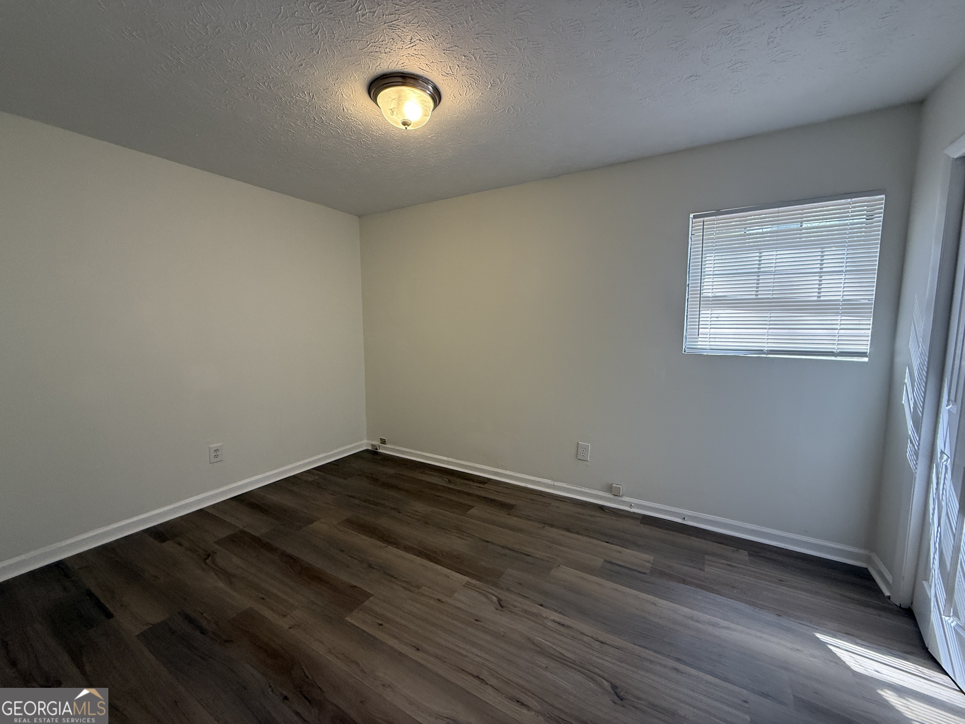 540 Rustwood Drive Athens, GA 30606 - Photo 5 of 6 an empty room with wooden floor and windows