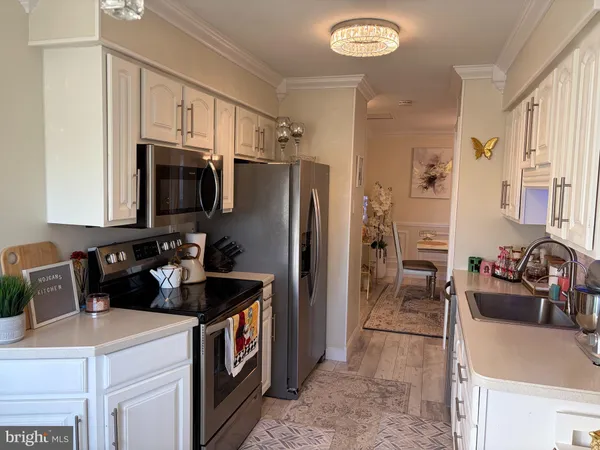a kitchen with a sink stove and refrigerator