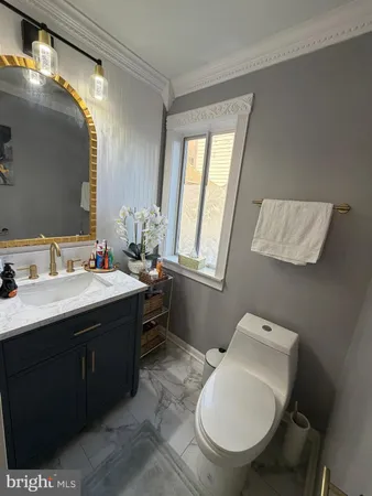 a bathroom with a toilet sink and mirror
