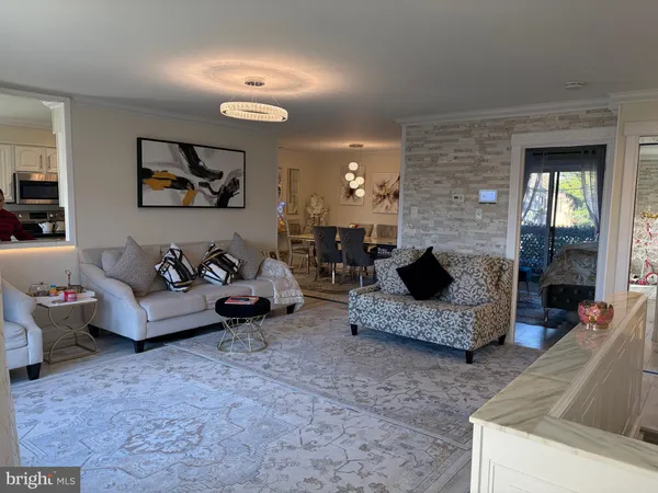 a living room with furniture and a chandelier